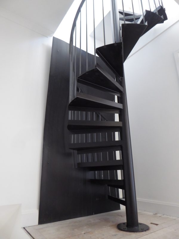 Spiral stairs leading up into a loft conversion.