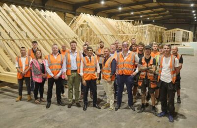 Rishi Sunak stood with Moduloft team in factory.