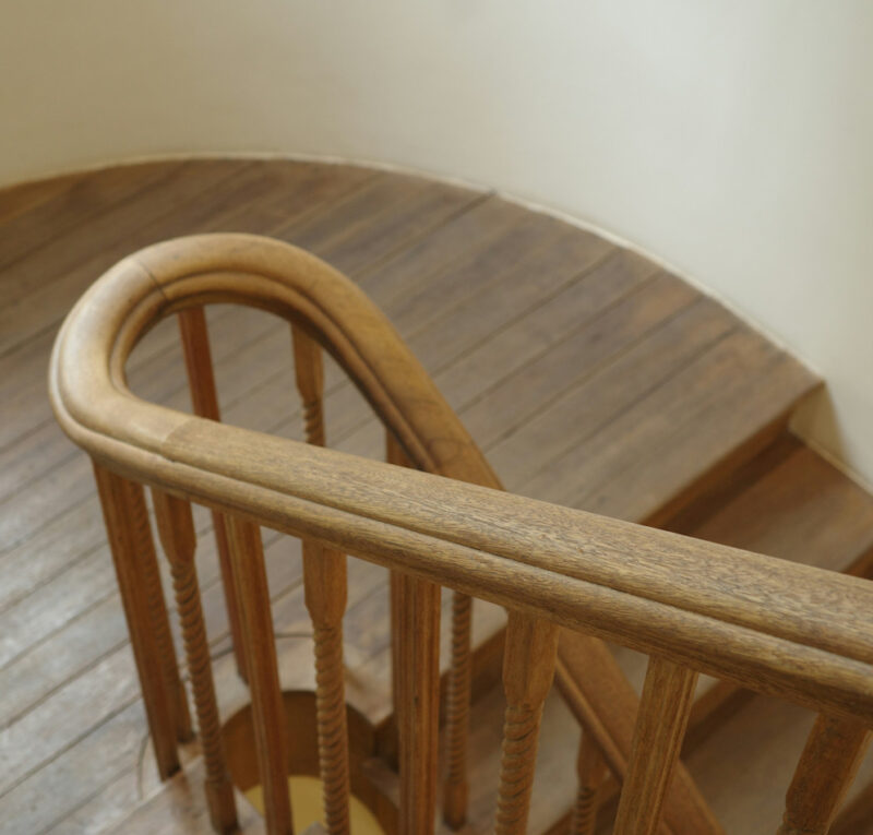 A wooden staircase with matching banisters.